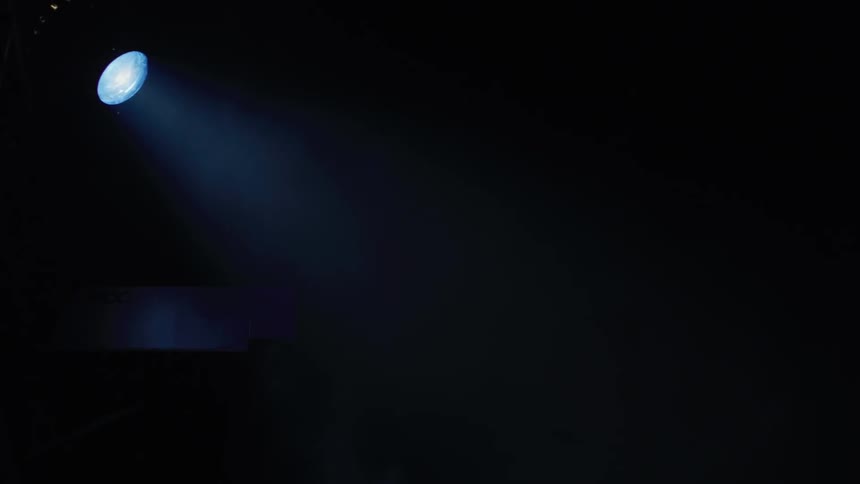 The spotlight shines in the dark