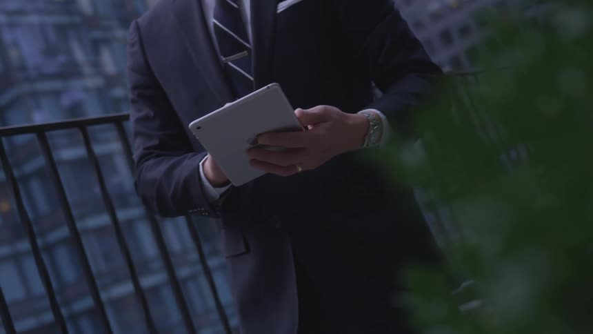 A man uses his tablet in the city