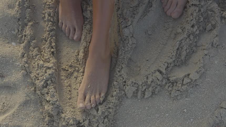 Three feet move in the sand