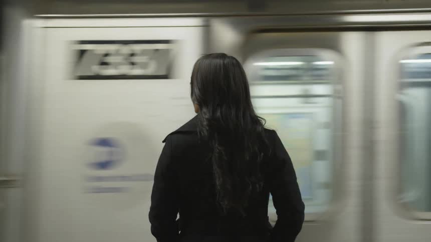 A woman waits for the train
