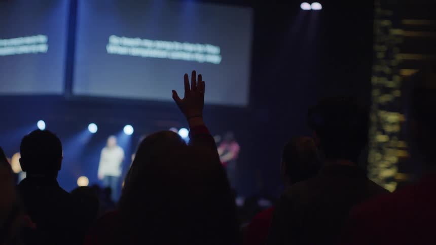 An audience watches a band perform on stage