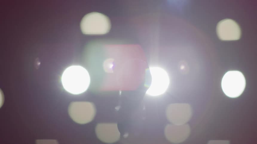Lights shine around a microphone