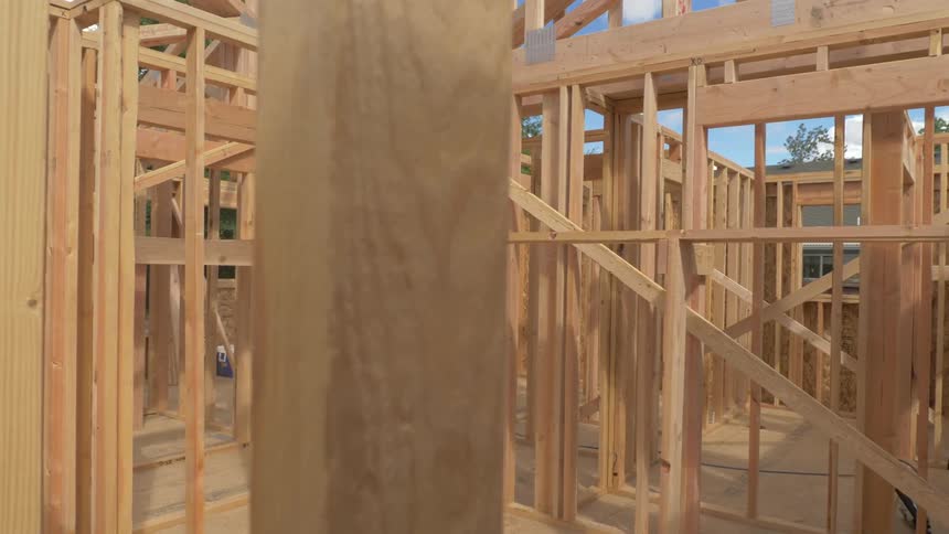 The framed walls of a house on a sunny day