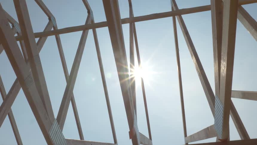 The sky is clear above the house frame