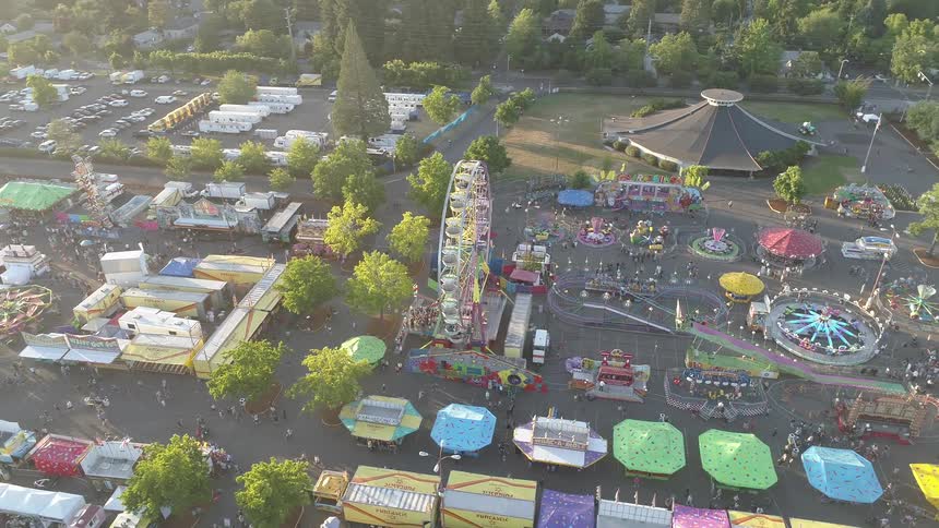 People walk around and go on rides at a carnival