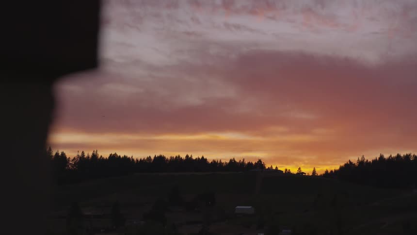 The sky is orange as the sun sets