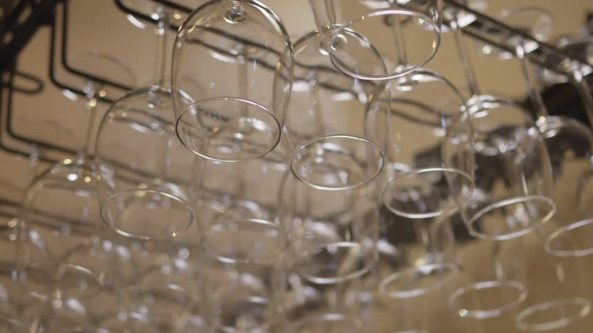 Glasses hanging upside down in rows
