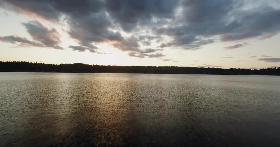 The sun is nearly set on the lake