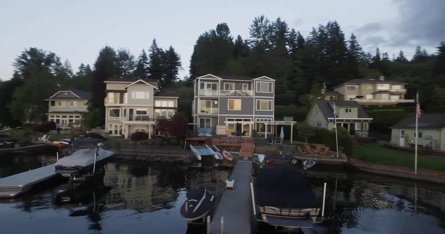The boats are docked by the homes