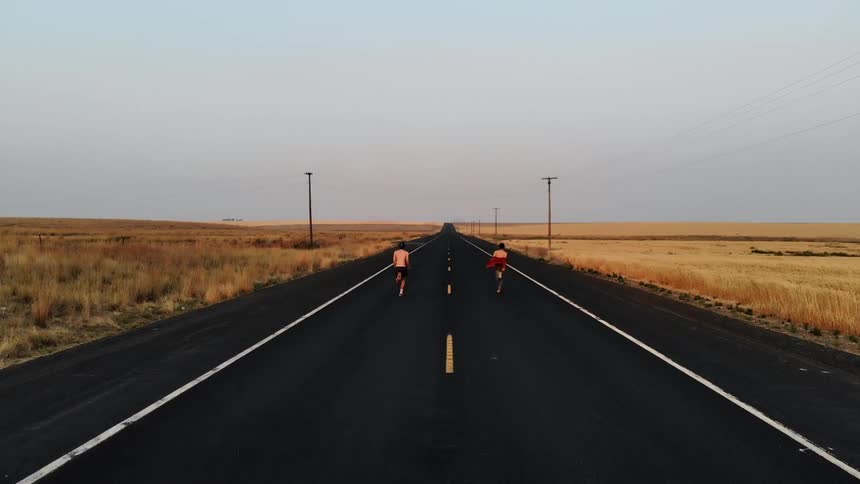 The three people jog down the road