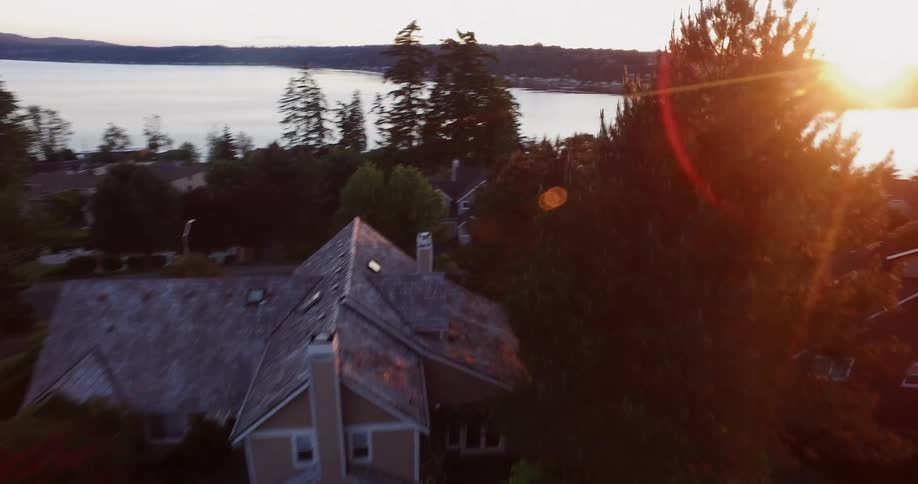 Sunlight is beaming down on a coastal community at dawn
