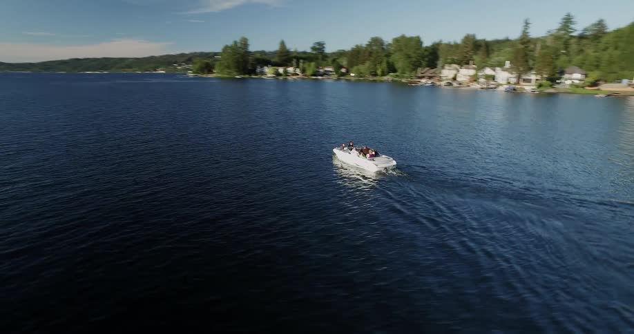 The boat is carrying people in the lake
