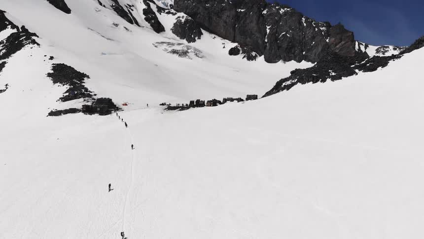 People walking on a snow covered mountain