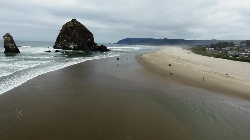 The beach has large rocks by the shore