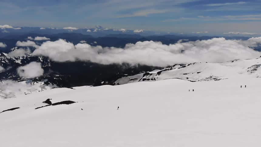 People ski on a mountain slope