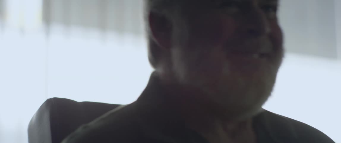 A man moves frantically in a chair