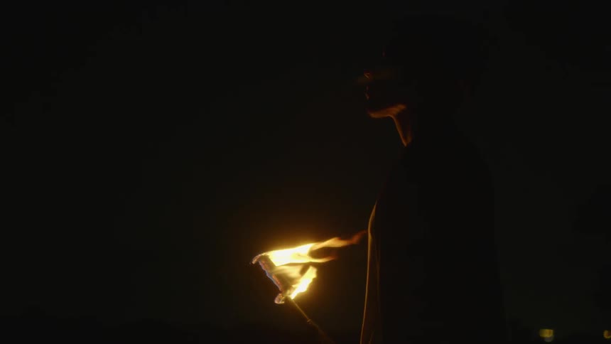 Fire burns on a torch in the dark