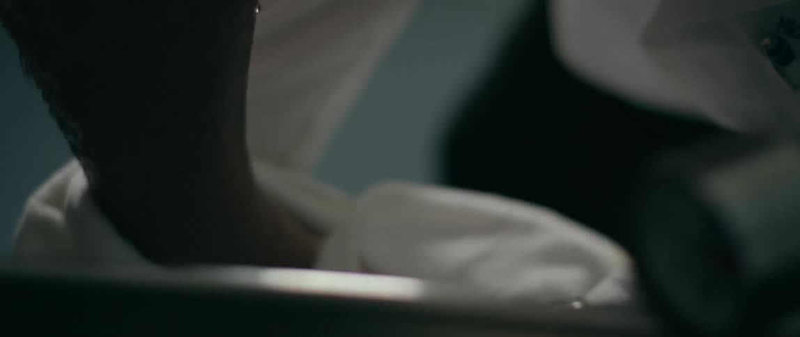 A person wipes another's legs from a tub