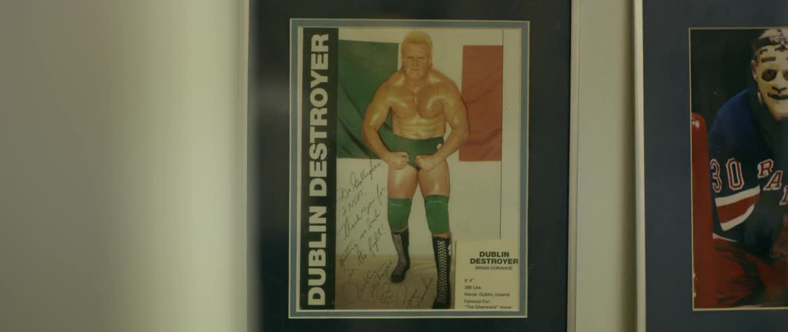 A wrestler is framed on the wall