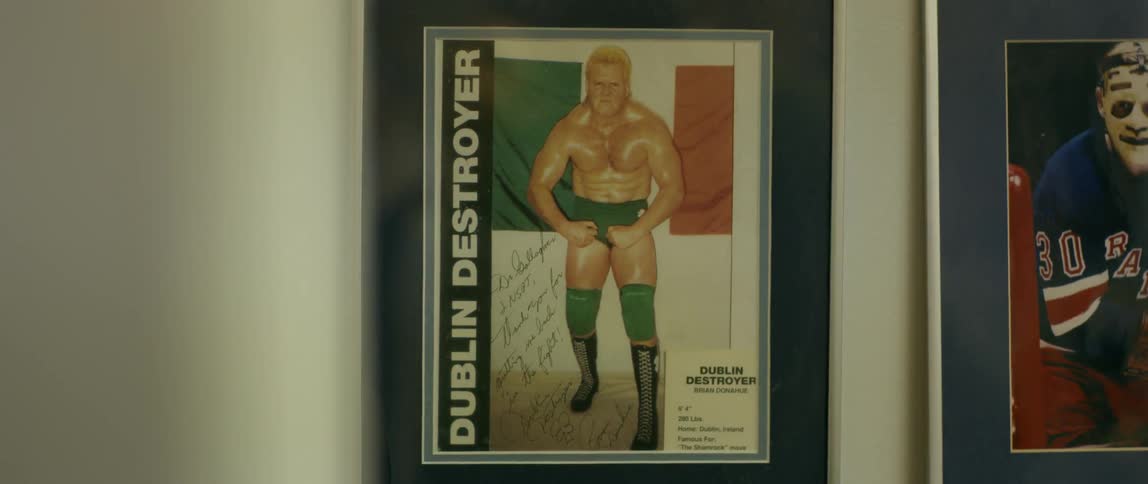 The a man walks past a picture on the wall