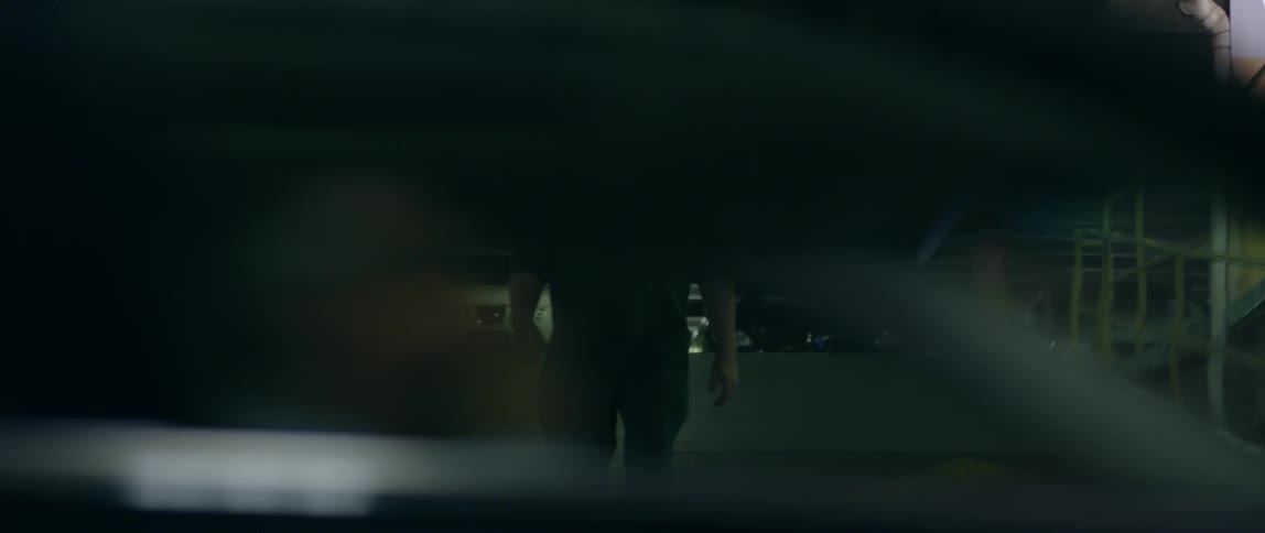 Man walks down a ramp in a parking garage