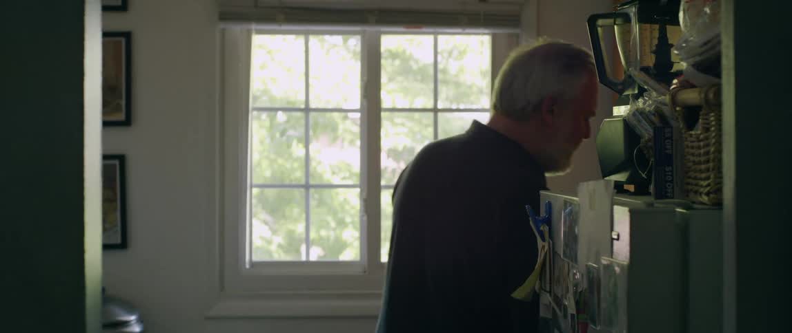 A man picks up a glass to drink