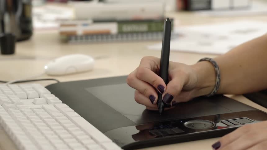 A woman writes on her sketch device