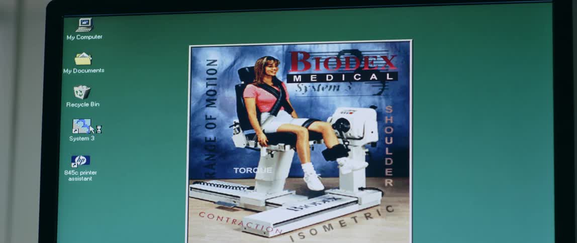 Computer monitor shows a picture of a woman on an exercise machine