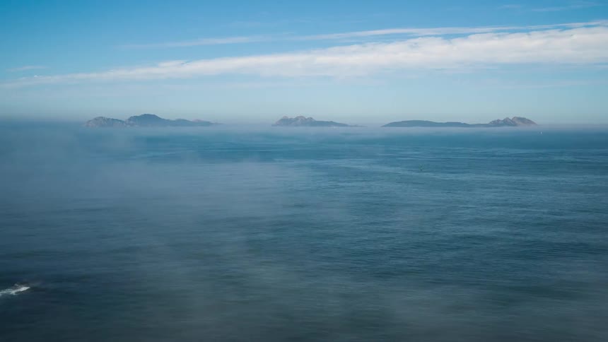 Clouds and fog move over the ocean surface