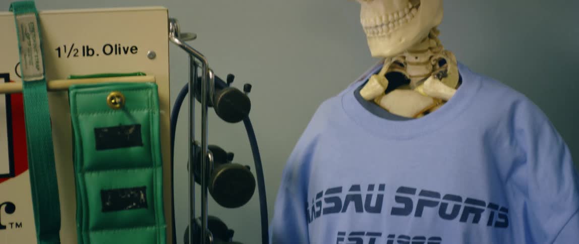 A skeleton has a t-shirt and hat on