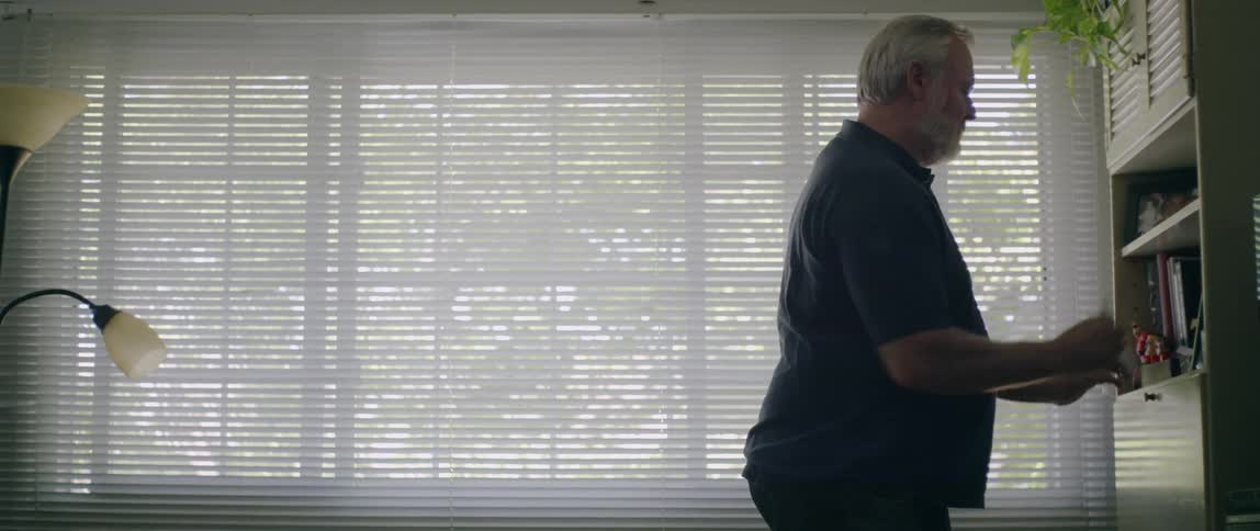 A man leans on his counter in the room