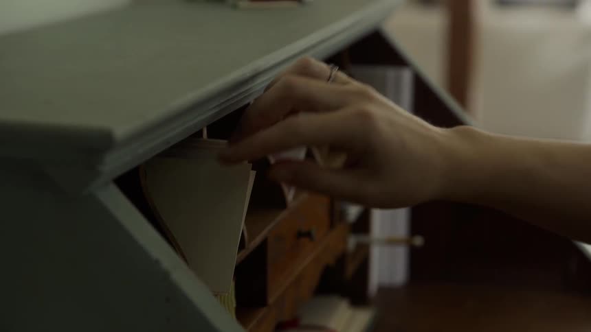 A person searches through their desk