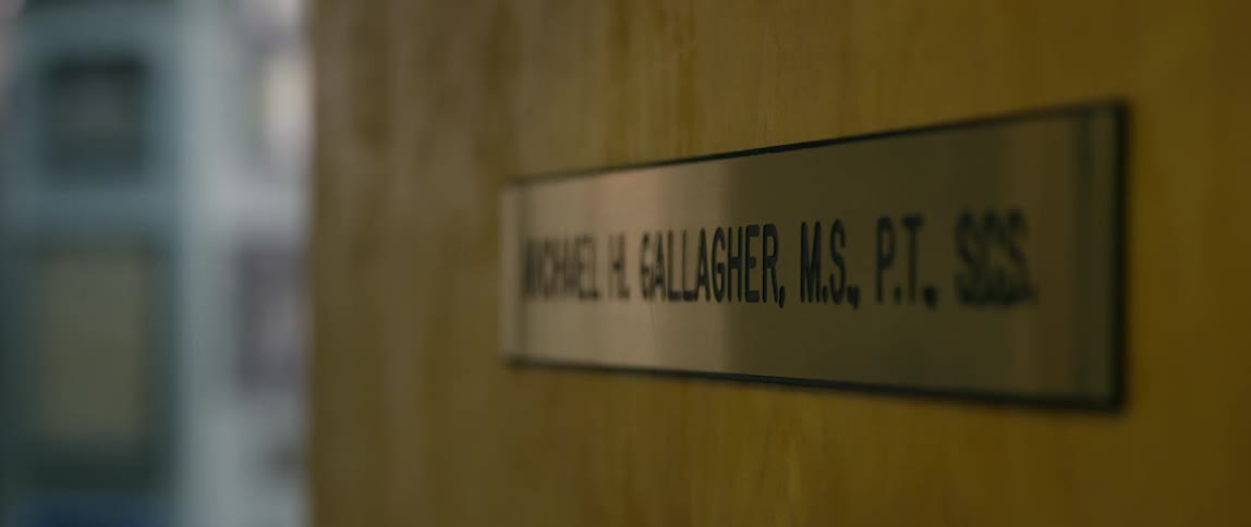 A physical therapist's name plate on a door