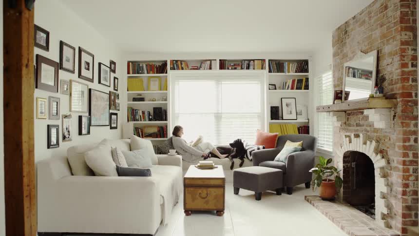 Woman Relaxes With Dog in Window Seat