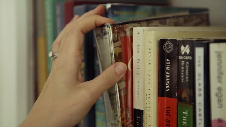 A person is searching through their library