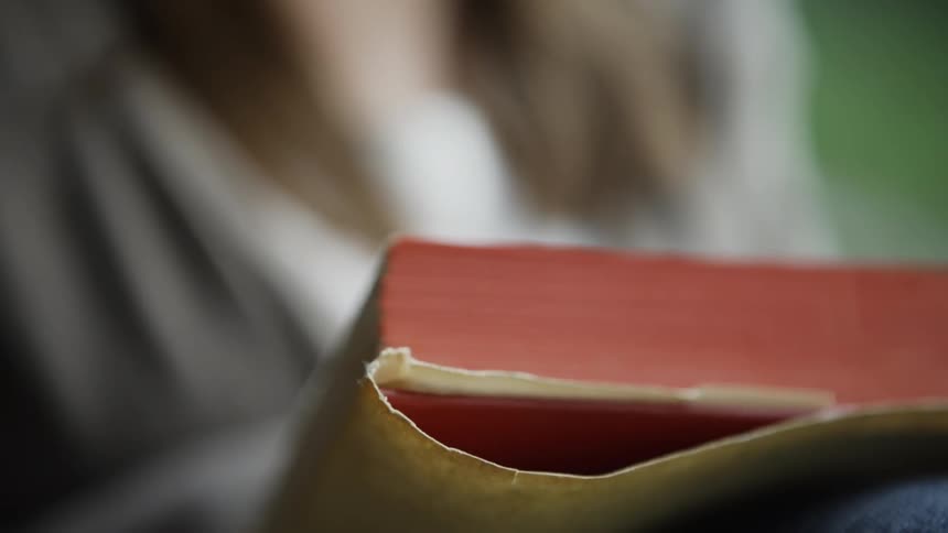 Close Up Of Fingers Turning Book Pages