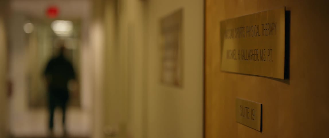 A man walks down a hallway and turns