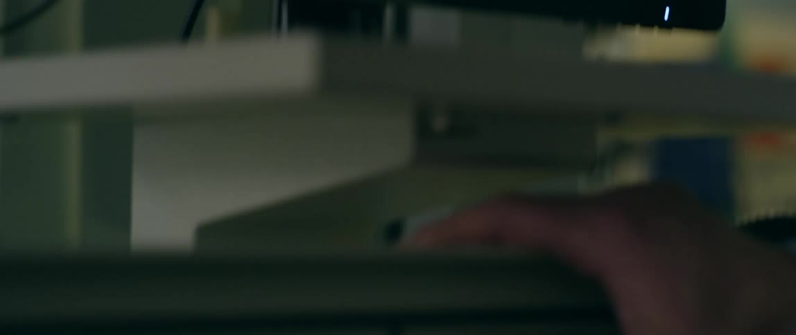 Computer monitor shows a program and a person pushes buttons below