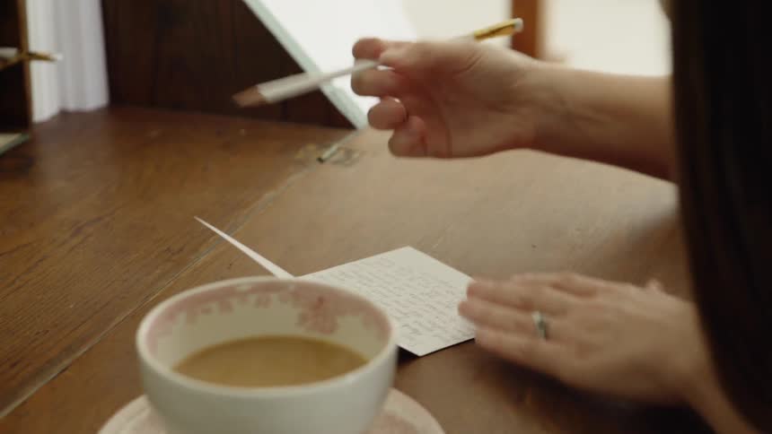 Woman Uses Pencil Eraser and Brushes Dust Away