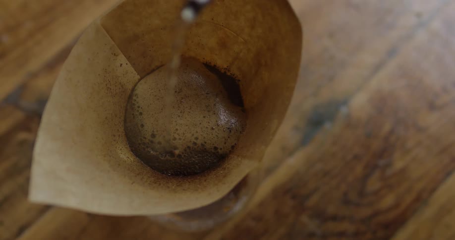 Liquid being poured slowly into a funnel