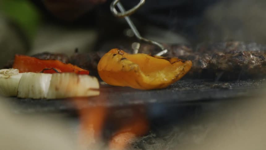 The person is cooking food on the grill