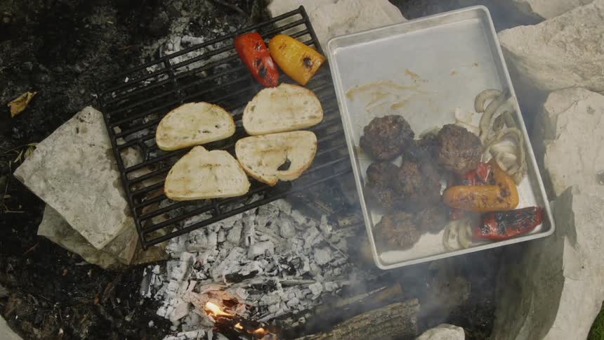 Food cooks on a smoking grill