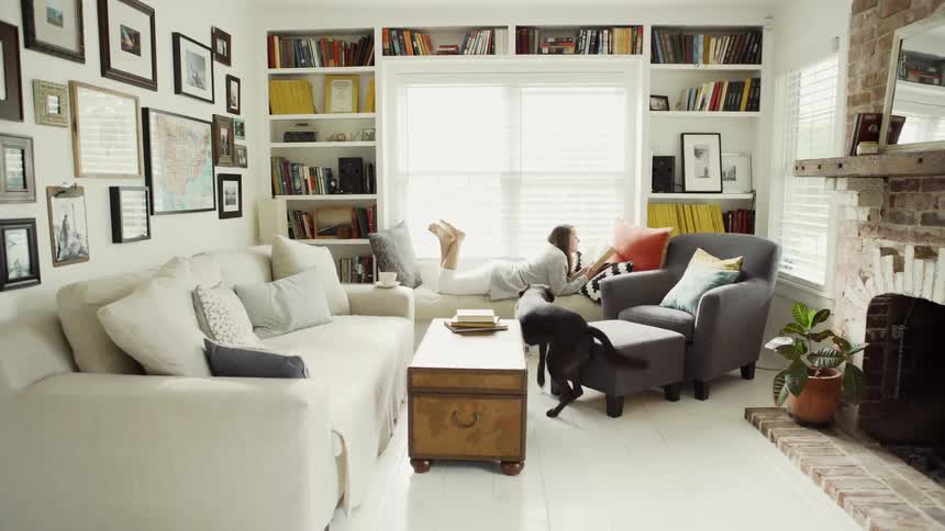 Woman Lies Down to Read and Dog Runs to Her