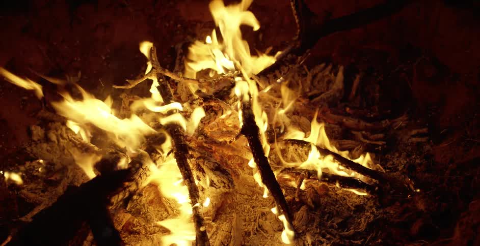A close up of a lit campfire at night time