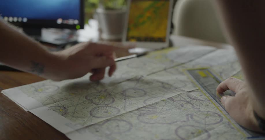 The man makes notes on a map