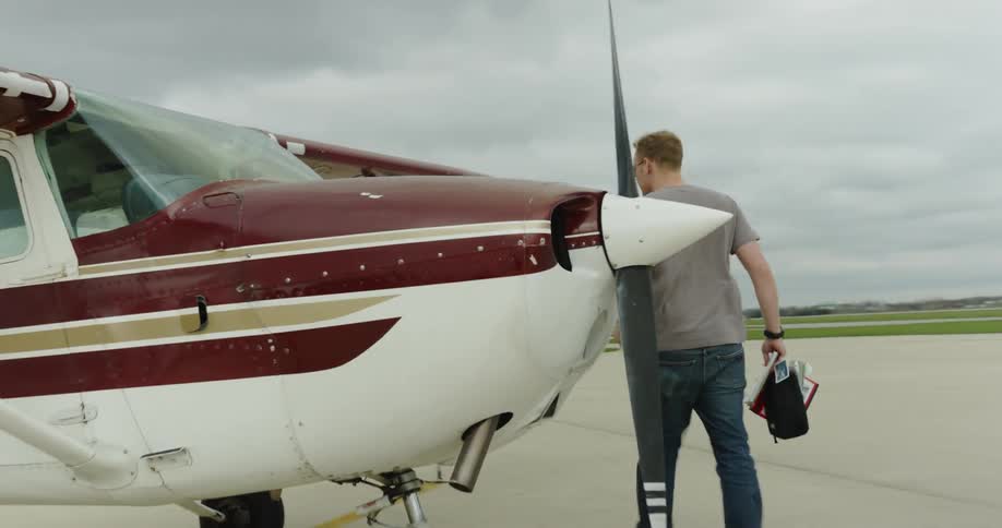 A man walks over to the airplane
