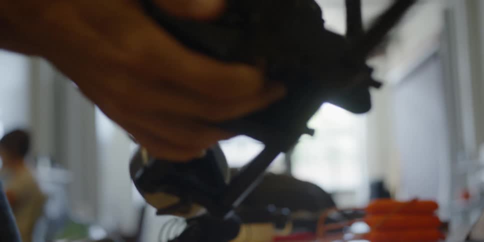 A man adjusts a camera stand