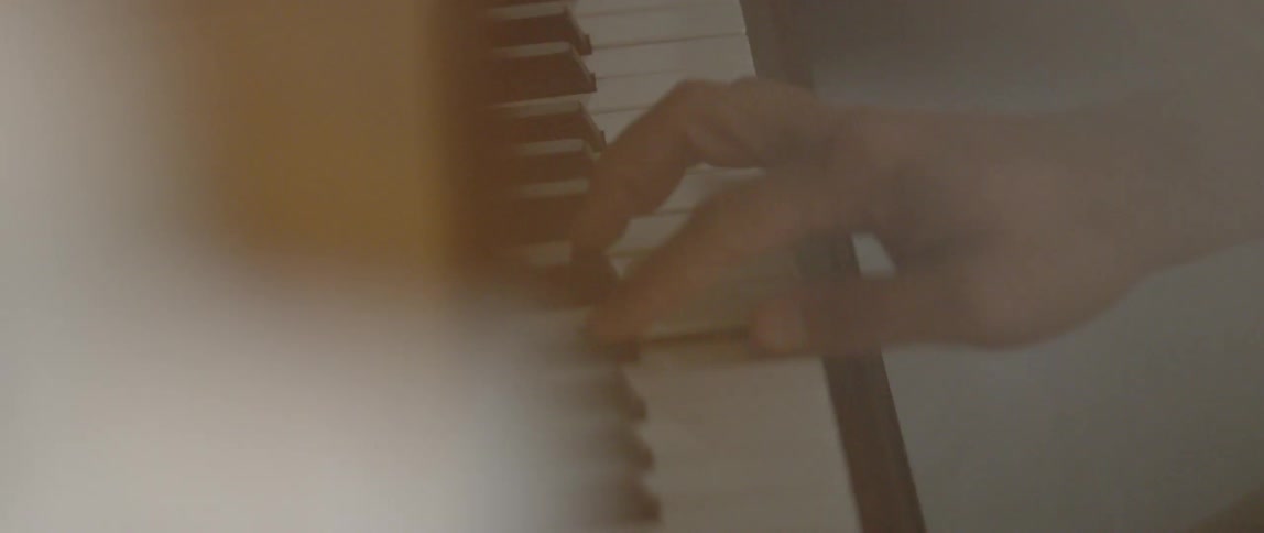 A person plays a piano