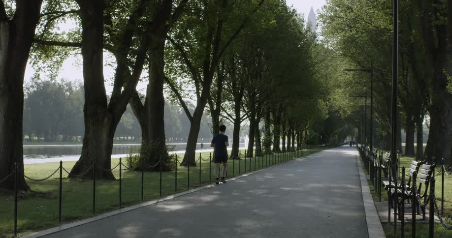 A man jogs in a park on the National Mall in Washington DC