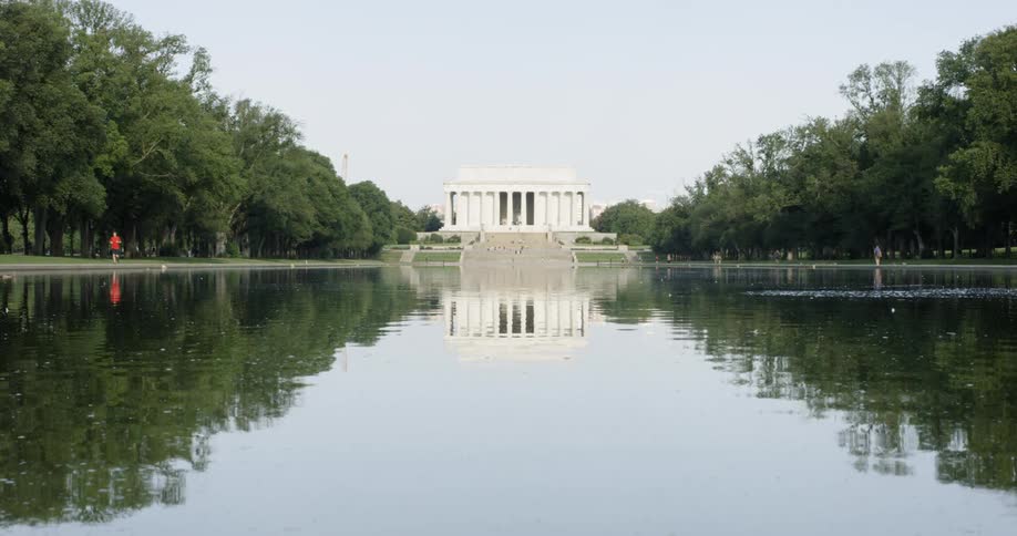 A person jogs near the Lincoln Memorial water on the national mall